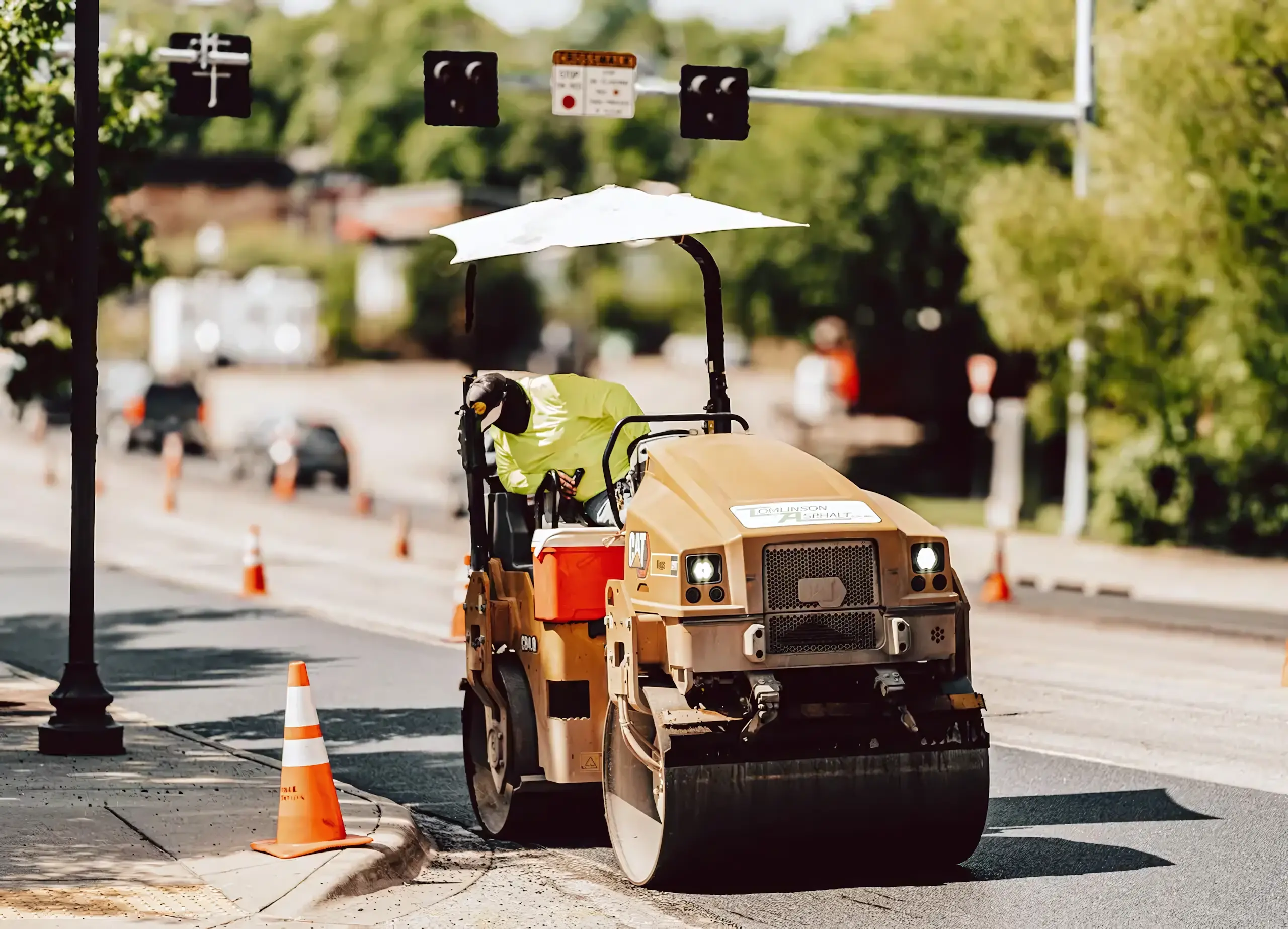 A Tomlinson Asphalt asphalt hopper at work on a paving job