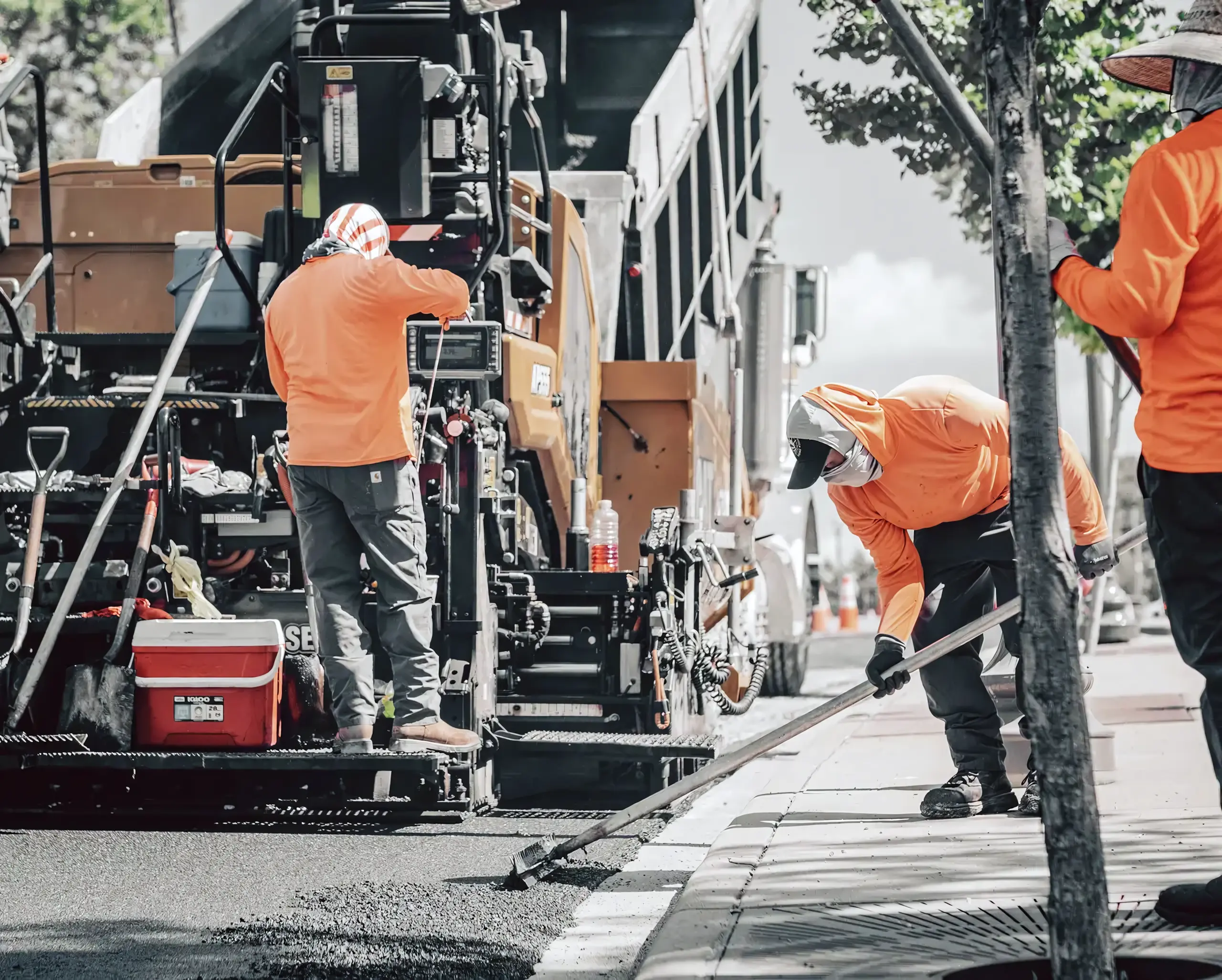 A Tomlinson Asphalt asphalt hopper at work on a paving job